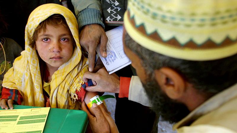 An Afghan refugee child receives a measles shot from a Medecins Sans Frontieres (Doctors Without Borders) 