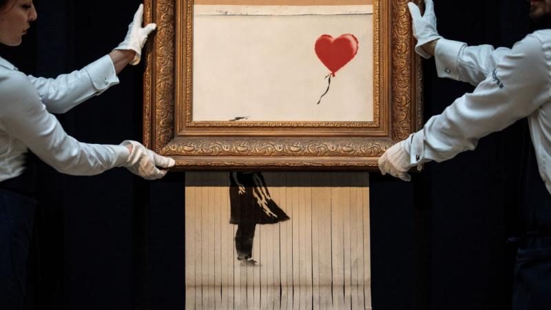 Shredded painting by Banksy re-sold at auction in London
