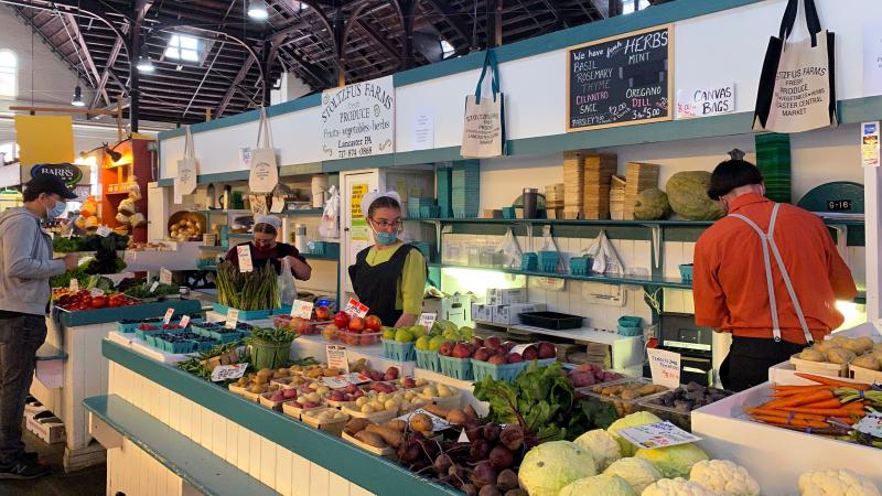 Shoppers and Amish vendors wearing masks attend Lancaster Central Market at Lancaster City, Pennsylvania on May 23, 2020.