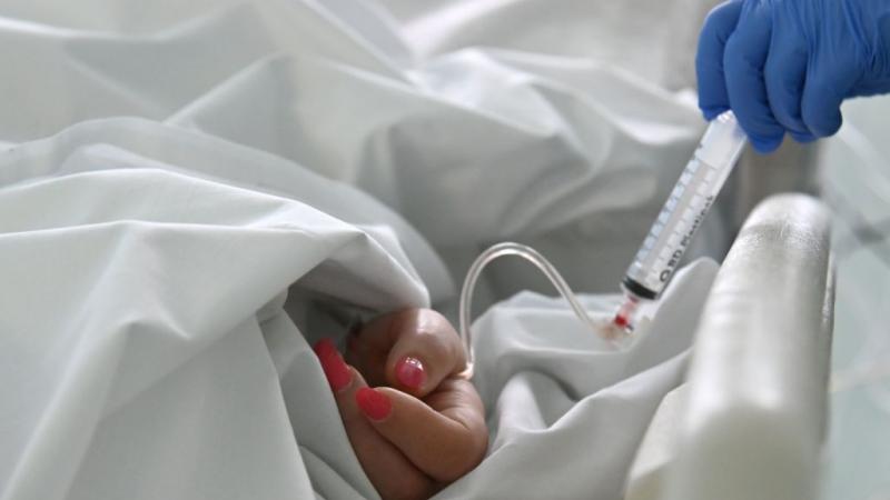 A medical staff performs an intravenous injection 