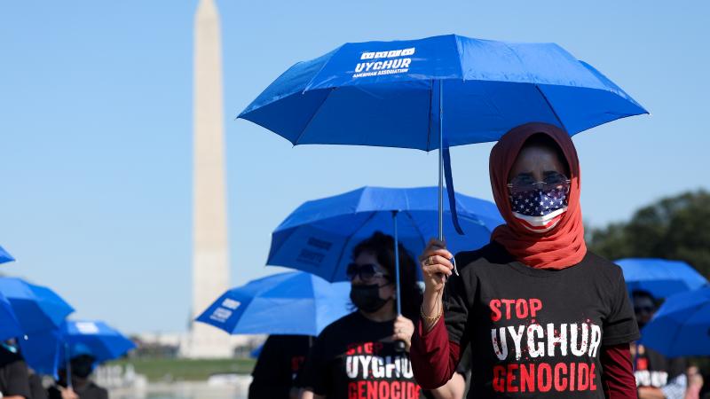 People take part in a demonstration to protest against China's policies towards Uyghur Muslims and other ethnic and religious minorities, on the 72nd anniversary of the founding of the People's Republic of China, on October 01, 2021 in Washington, United States.