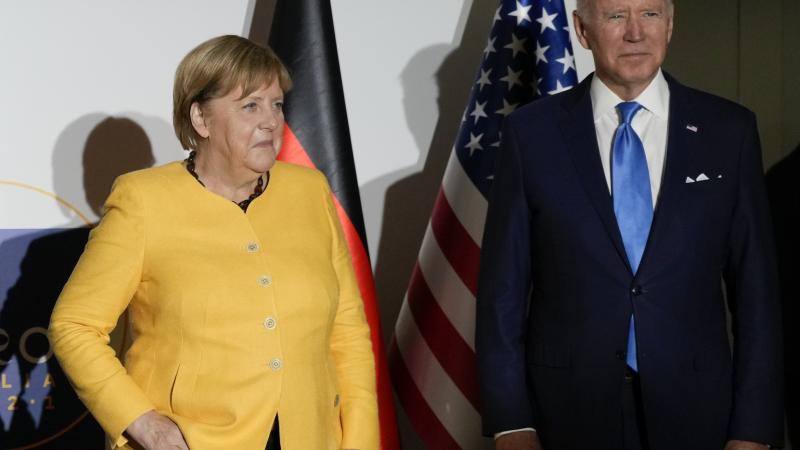 German Chancellor Angela Merkel, left, and U.S. President Joe Biden pose for the media at the La Nuvola conference center for the G20 summit on October 30th, 2021 in Rome, Italy.