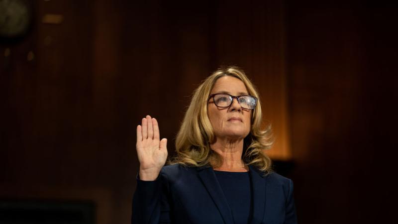Christine Blasey Ford is sworn in prior to giving testimony before the U.S. Senate Judiciary Committee