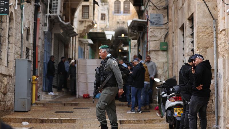 Israeli police officers and border guards guard as they inspect the site after a Palestinian killed by Israeli forces for "armed attack" in the Old City of Jerusalem on November 21, 2021.
