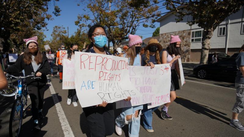 Protesters hold placards during the demonstration. Around two hundred people marched on the streets of Alameda to defend women's rights. Their demands included the right to abortion across the United States