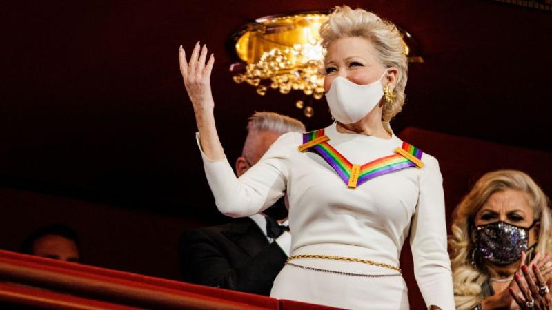 Honoree US singer and actress Bette Midler acknowledges applause as she attends the 44th Kennedy Center Honors at the Kennedy Center in Washington, DC, on December 5, 2021