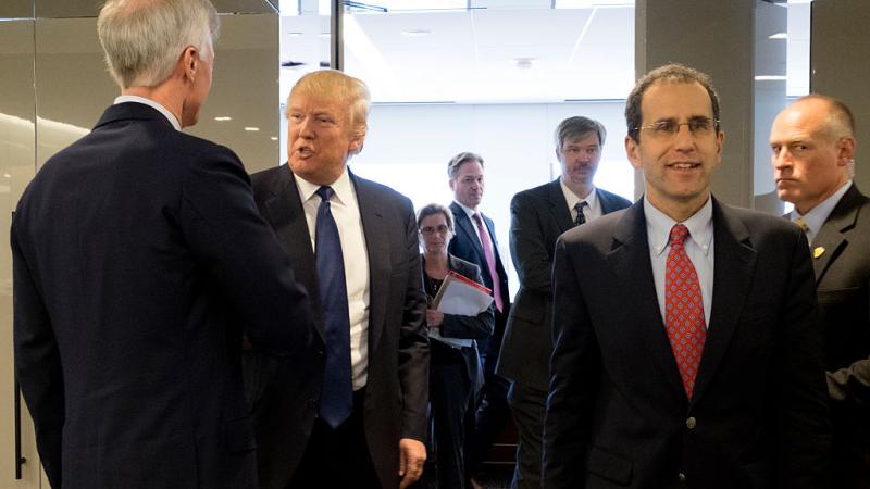 Then Presidential candidate Donald Trump departs a meeting with the Editorial Board of The Washington Post. Editorial page editor Fred Hiatt is on the right.