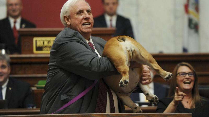 West Virginia Gov. Jim Justice hold up his dog during State of the State speech