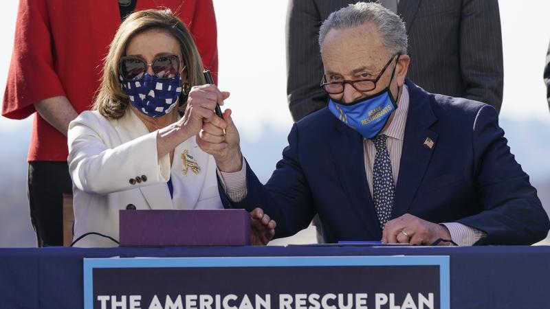 Nancy Pelosi and Chuck Schumer sign American Rescue Plan