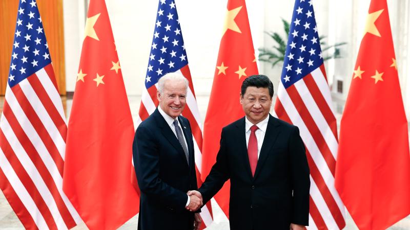 Chinese President Xi Jinping (R) shake hands with U.S Vice President Joe Biden (L) inside the Great Hall of the People on December 4, 2013 in Beijing, China.
