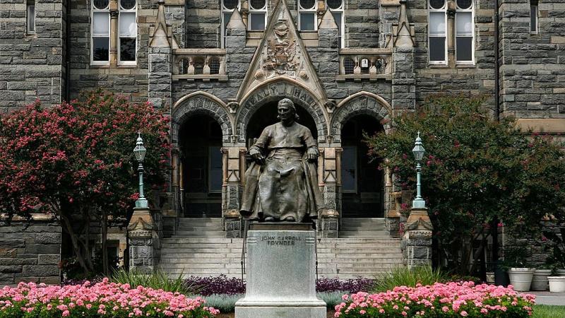 A statue of John Carroll, founder of Georgetown University, sits before Healy Hall on the school's campus