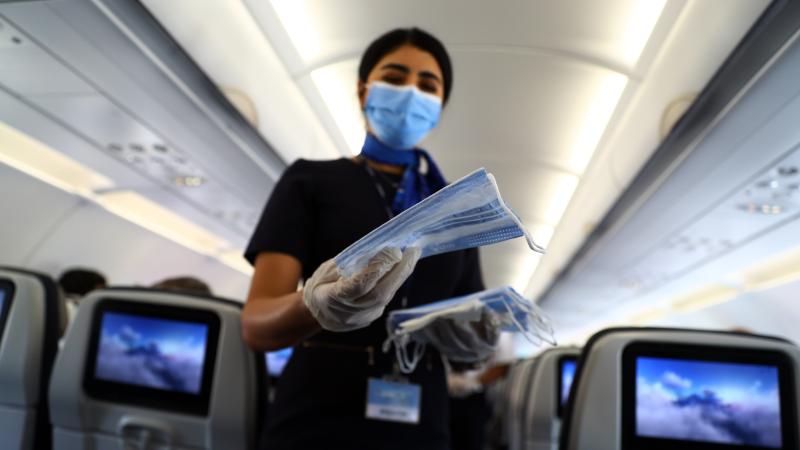 Stewardess with face masks on airplane, Egypt, June 18, 2020