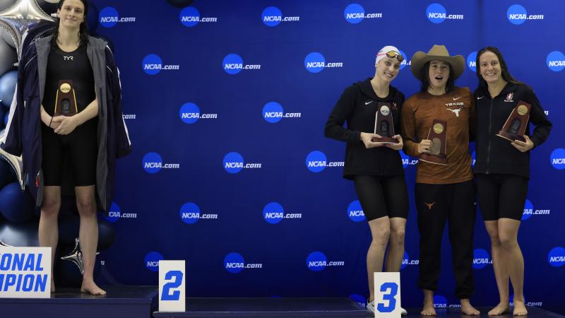 Transgender woman Lia Thomas (L) of the University of Pennsylvania stands on the podium after winning the 500-yard freestyle as other medalists (L-R) Emma Weyant, Erica Sullivan and Brooke Forde pose for a photo at the NCAA Division I Women's Swimming & Diving Championship on March 17, 2022 in Atlanta, Georgia.