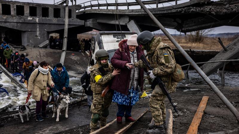 Ukrainian soldiers evacuate civilians from Irpin, March 7, 2022