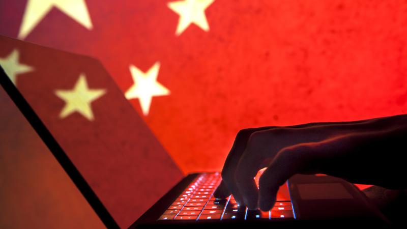 Stock photo of cyber hacker with China flag