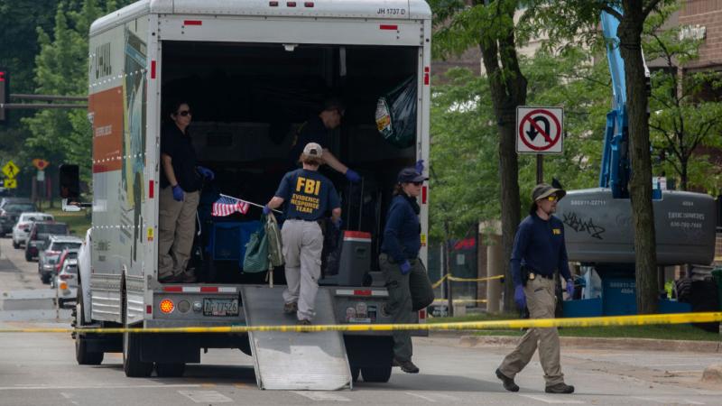 Investigators at the scene of the shooting, July 7