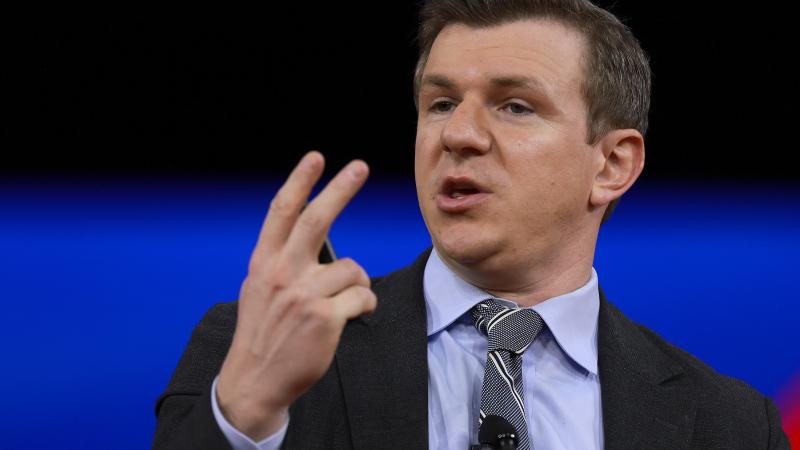 James O'Keefe holding up two fingers