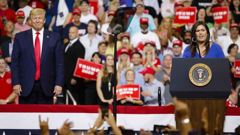 Trump on stage with Sarah Huckabee Sanders