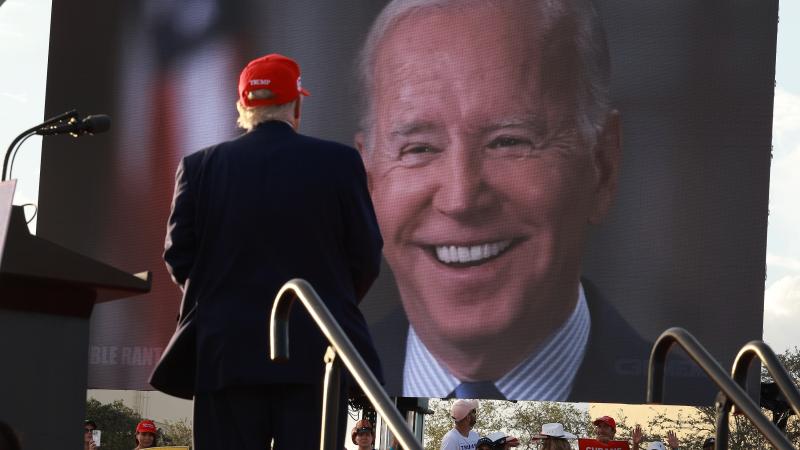 Trump at rally viewing image of Biden smiling 