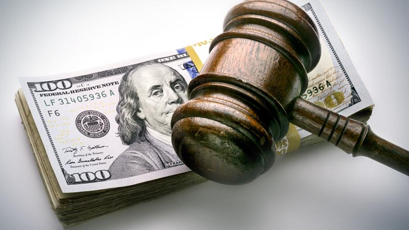 Gavel over stack of cash