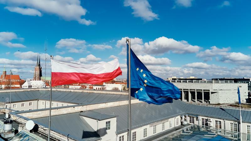 Waving Polisg Flag And European Union Flag On Building