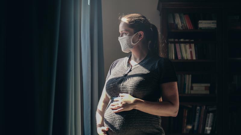 Pregnant woman in mask for COVID
