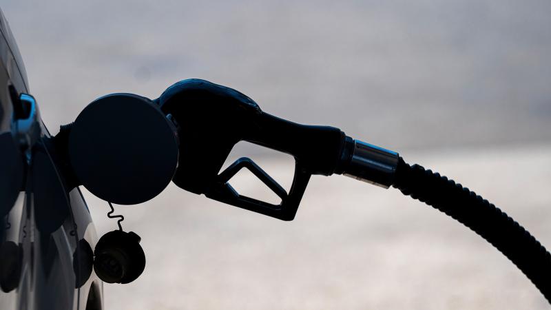 A fuel pump nozzle in a vehicle at a gas station.