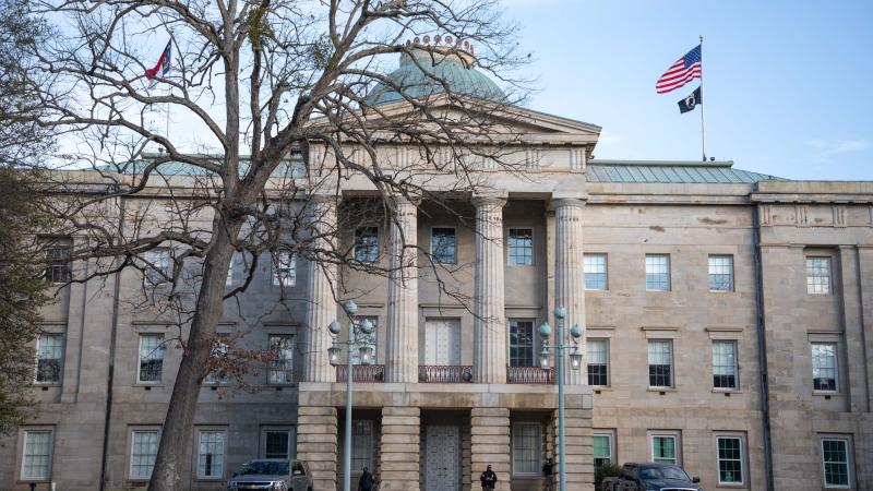 Law enforcement stand guard outside of the state capitol building in downtown Raleigh, North Carolina, on January 17, 2021