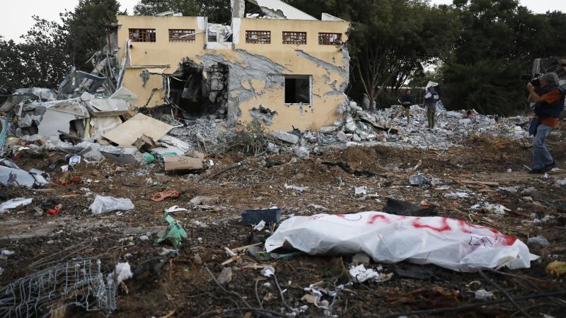 A body bag lies in front a destroyed building after Hamas launched Operation Al-Aqsa Flood in Israel on October 11, 2023.