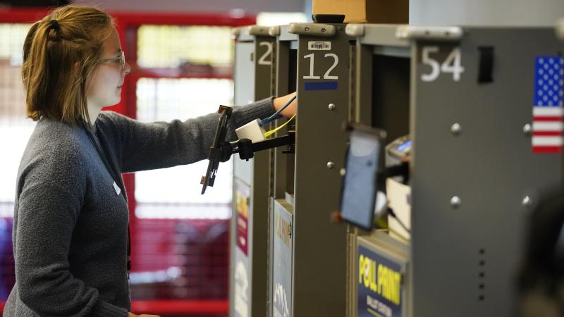 An election worker prints a ballot out for a voter at the Utah County Justice and Health center on November 8, 2022 in Provo, Utah.