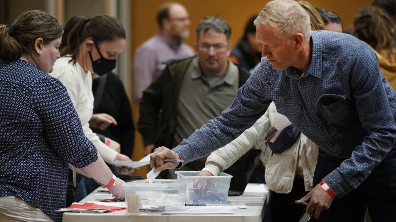 A voter casts his choice for the Republican presidential candidate on a slip of paper during the Republican Caucasus at Wasatch Elementary school in Provo, Utah on Super Tuesday, March 5, 2024.
