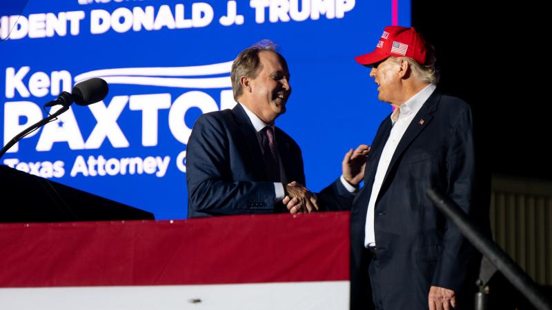 Texas Attorney General Ken Paxton greets former U.S. President Donald Trump at the 'Save America' rally on October 22, 2022 in Robstown, Texas.