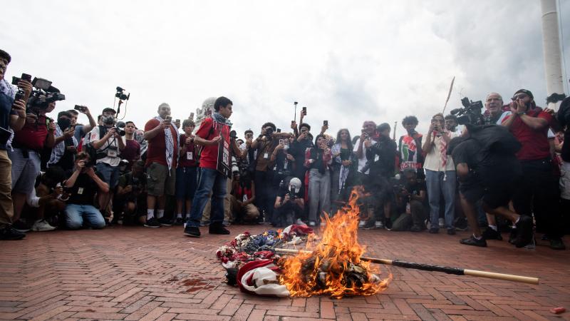 Protesters burn US flag at Union station.