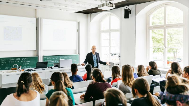 University Professor Addressing His Pupils During Lecture - stock photo  