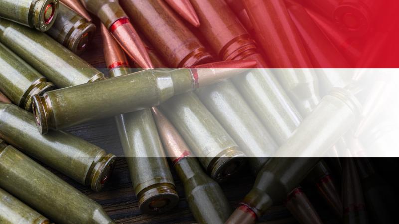 Yemen flag on the background of machine gun cartridges