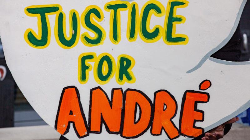 Protest sign for the death of Andre Hill