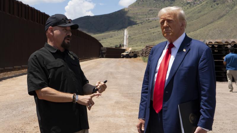 SIERRA VISTA, ARIZONA - AUGUST 22: National Border Patrol Council board member Art Del Cueto walks with U.S. Republican Presidential Candidate and former President Donald Trump along the U.S.-Mexico border on August 22, 2024 south of Sierra Vista, Arizona. Trump will hold a rally in Glendale, Arizona tomorrow. (Photo by Rebecca Noble/Getty Images)
