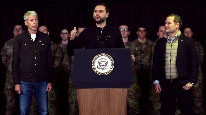 US Vice President JD Vance (C), with Secretary of Energy Chris Wright (L) and National Security Advisor Mike Waltz (R), speaks at the US military's Pituffik Space Base on March 28, 2025 in Pituffik, Greenland. 