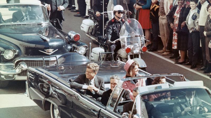 US President John F Kennedy, First Lady Jacqueline Kennedy, Texas Governor John Connally, and others smile at the crowds lining their motorcade route in Dallas, Texas, on November 22, 1963. Minutes later the President was assassinated as his car passed through Dealey Plaza.