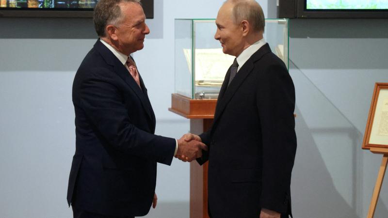 In this pool photograph distributed by the Russian state agency Sputnik, Russia's President Vladimir Putin shakes hands with US President Donald Trump's envoy Steve Witkoff during a meeting in Saint Petersburg on April 11, 2025