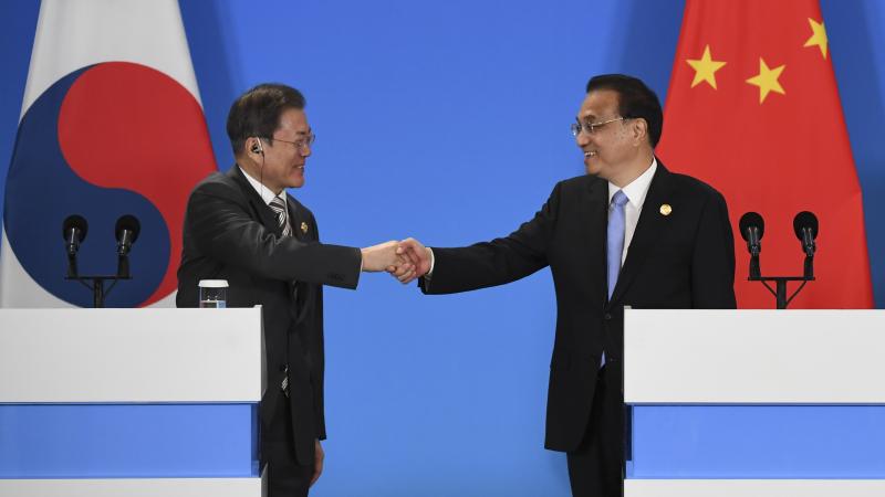 China's Premier Li Keqiang (R) South Korea's President Moon Jae