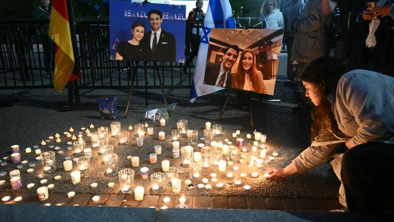People attend a candlelight vigil at Lafayette Square across from the White House in Washington, DC on May 22, 2025, following a shooting that left two people dead.