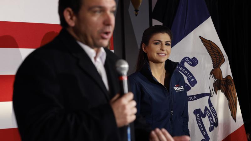 Casey DeSantis (R) listens as her husband, Republican presidential candidate Florida Gov. Ron DeSantis, speaks during a campaign event at the Chrome Horse Saloon one day before the Iowa caucuses on January 14, 2024 in Cedar Rapids, Iowa.