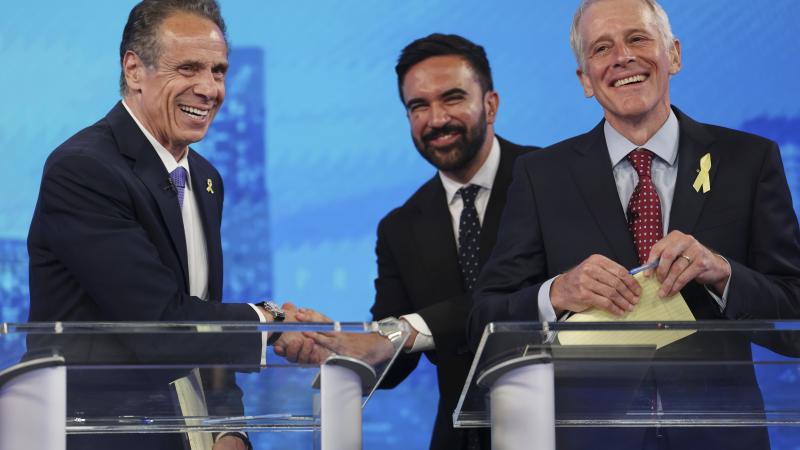 Democratic mayoral candidates Andrew Cuomo, left, shakes hands with Zohran Mamdani, center, as Whitney Tilson reacts after participating in the New York City Democratic Mayoral Primary Debate at NBC Studios on June 4, 2025 in New York City.