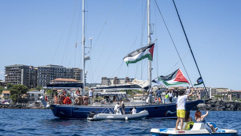 Just before the departure of the Madleen, the Freedom Flotilla vessel, a young man raises the Palestinian flag from a pedal boat as other boats fly the same flag off the port of San Giovanni Li Cuti on June 01, 2025 in Catania, Italy.