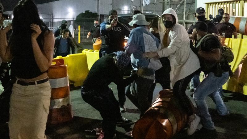 A police officer sprays pepper spray at anti-U.S. Immigration and Customs Enforcement (ICE) activists trying to block a car leaving from Delaney Hall, a migrant detention facility, on June 12, 2025 in Newark, New Jersey.
