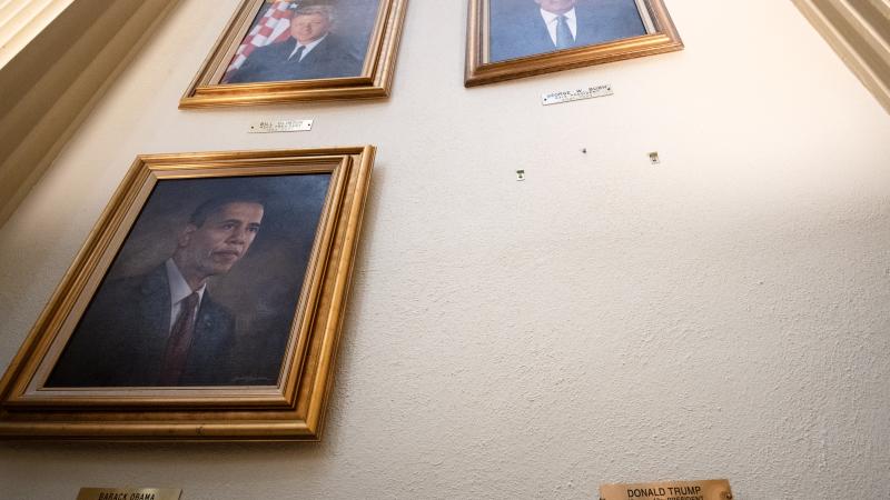 Mounting screws and a small plaque bearing the name of US President Donald Trump are all that remain on a wall in the Presidential Portrait Gallery where a portrait of Trump once hung at the Colorado Capitol in Denver, Colorado on March 25, 2025.