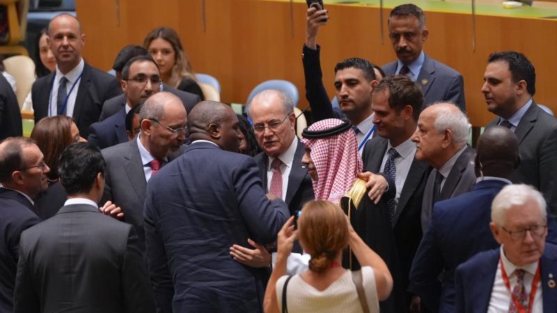 UK Foreign Secretary David Lammy greets Palestinian Prime Minister Mohammad Mustafa following his speech at the High-Level International Conference