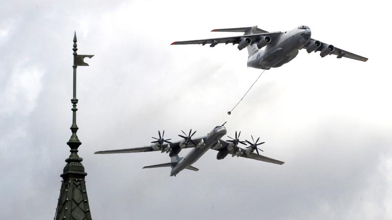 Russian Tupolev TU-95MS strategic bomber and Ilyushin IL-78 military plane fly over the Kremlin during the general rehearsals of the Victory Day Parade inf front of the Kremlin at Red Square, on May 7, 2021 in Moscow, Russia