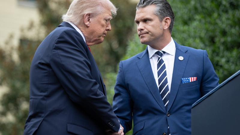 U.S. President Donald Trump greets Secretary of War Pete Hegseth (R) during a September 11th observance event in the courtyard of the Pentagon September 11, 2025 in Arlington, Virginia